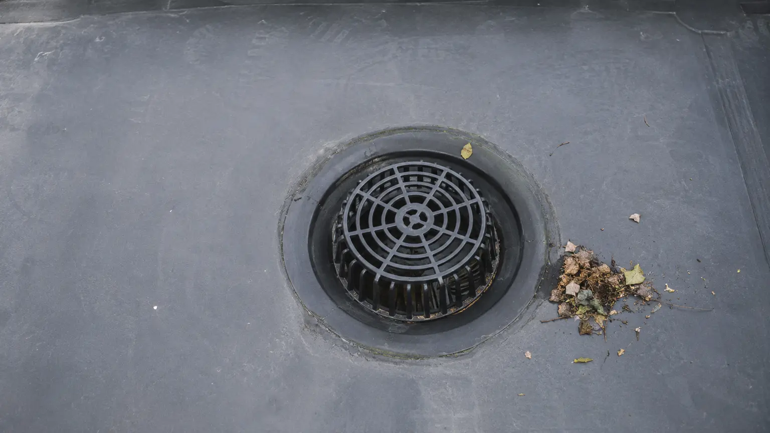 Flat roof drainage outlet showing standing water risk
