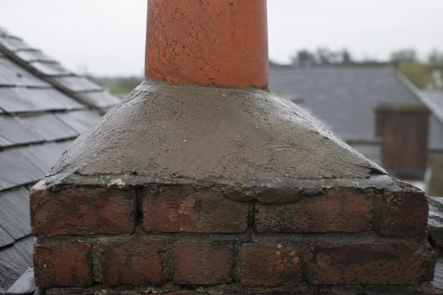 Mortar flaunching bedding a chimney pot
