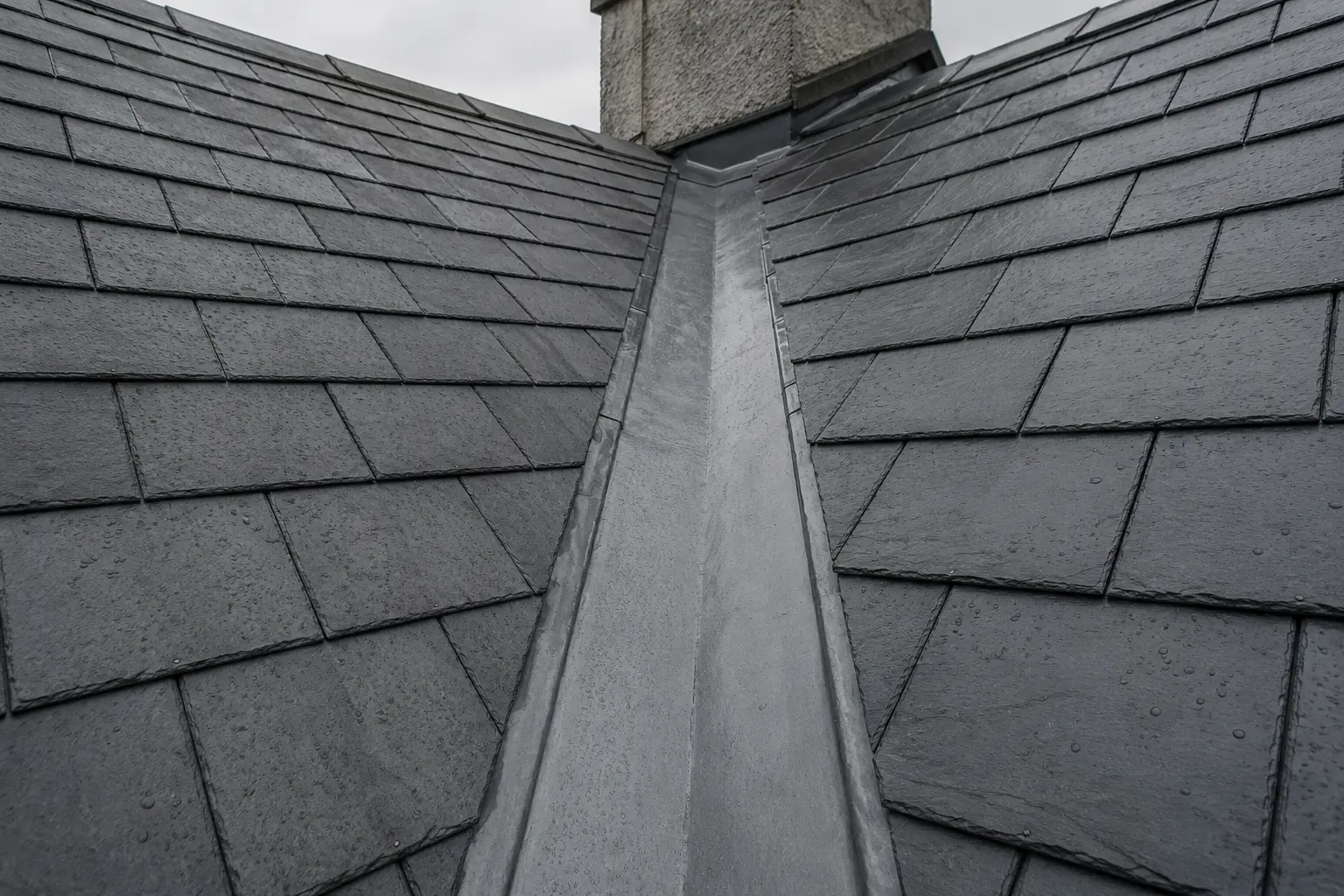 A finished lead valley running between two roof slopes