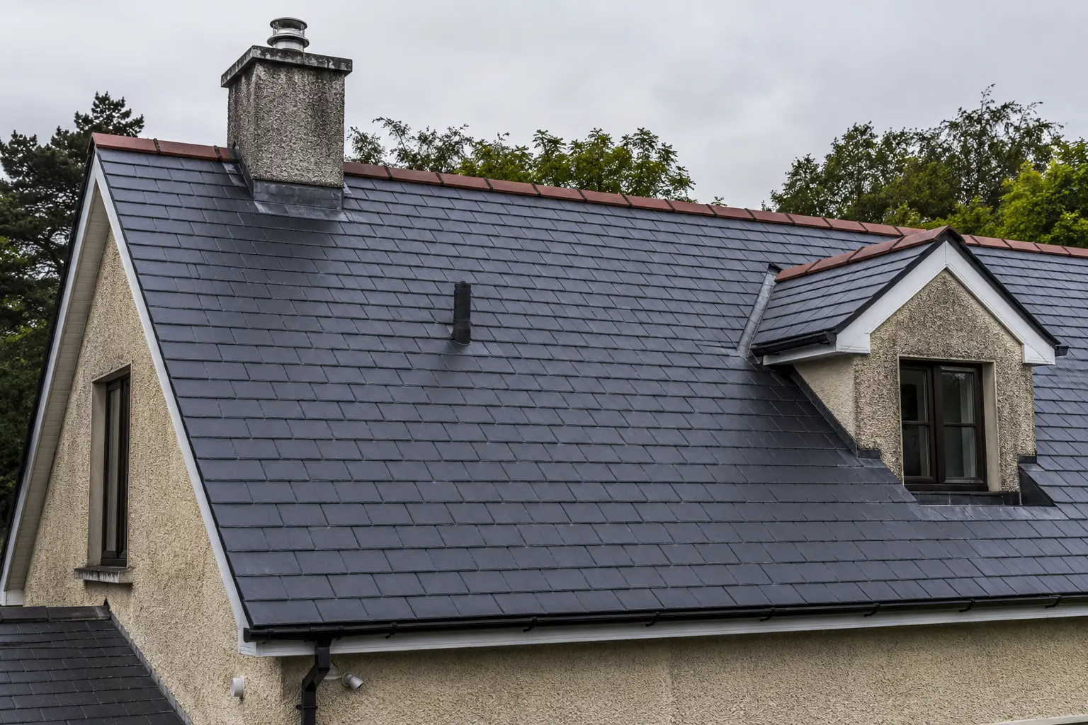 A completed slate re-roof on an Irish house with a dormer