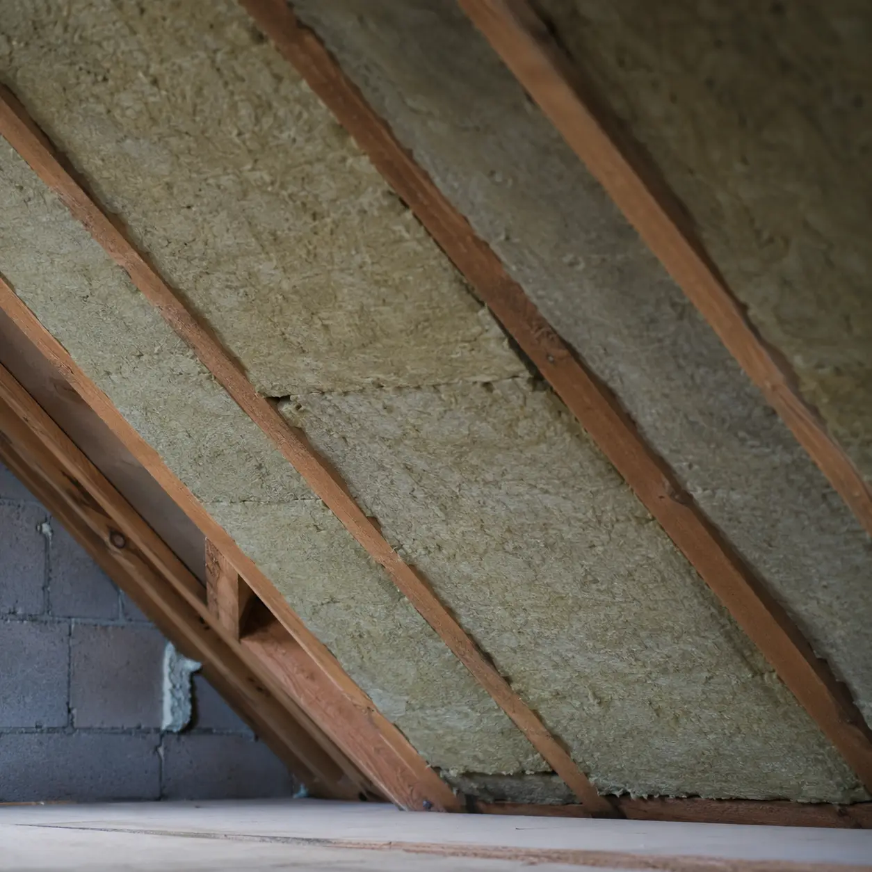 Attic insulation and roof timbers exposed during a re-roof