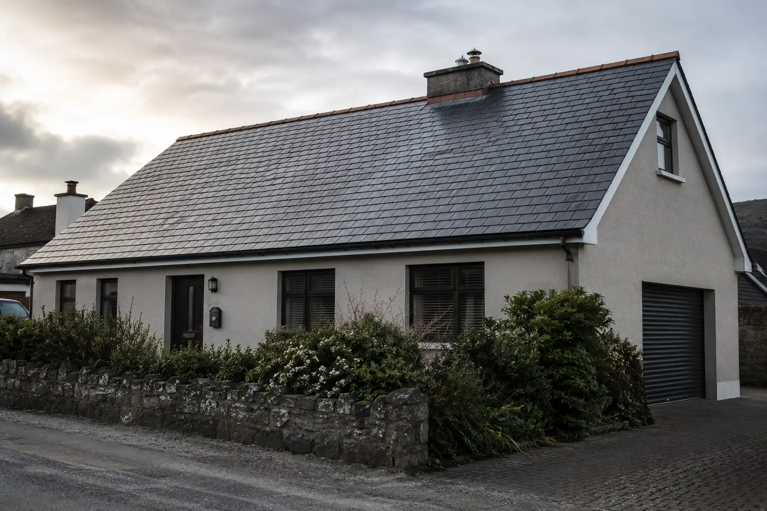 Cracked and slipped slate tiles on an Irish terraced house roof