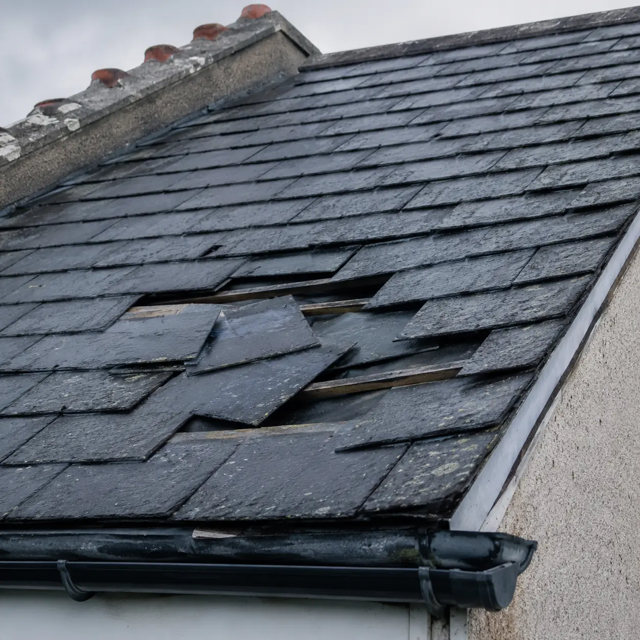Slipped slates exposing the battens on an Irish slate roof